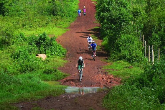 Cyclists on a mountain biking trail along Uganda River Expeditions