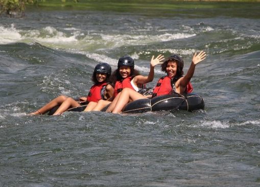 People relaxing while tubing on the Nile River in Jinja